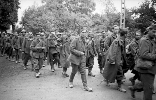 Milhares de prisioneiros de guerra franceses marcham para longe do front, em maio de 1940. 